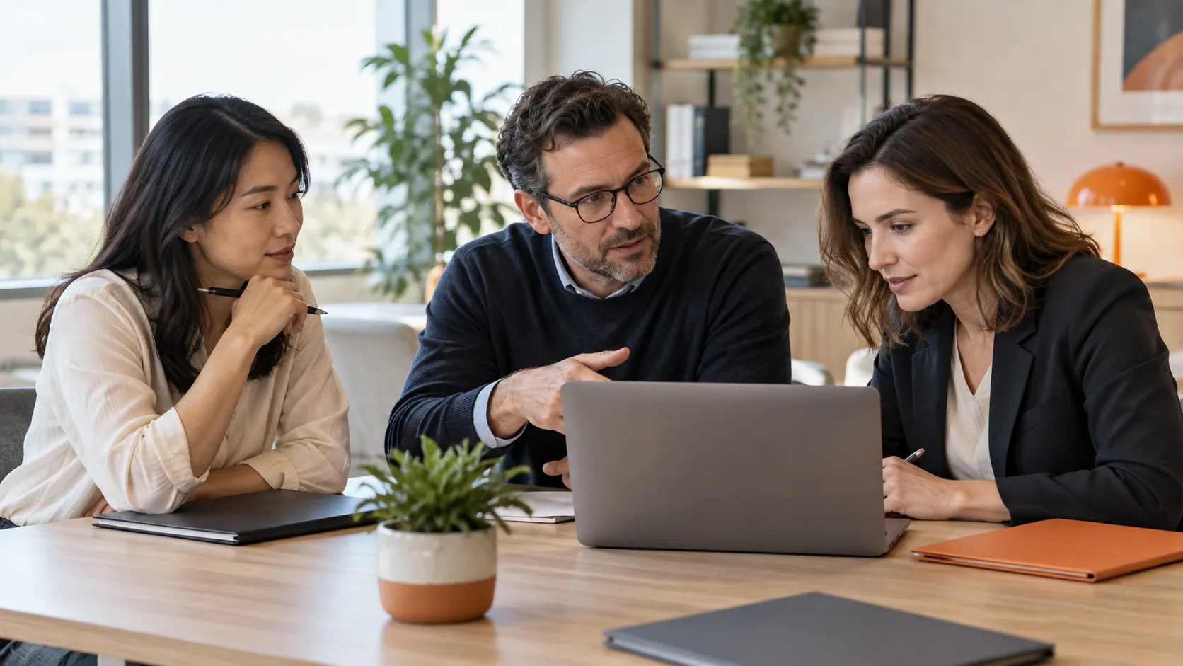 Three medical professionals from different demographics discussing and evaluating documents around a table in a bright research office.